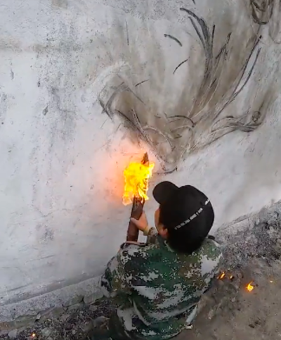 Artist Creates Unique Murals With The Char Of A Flaming Stick