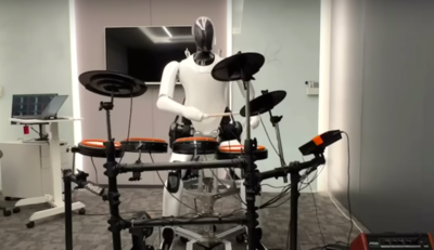 A Bipedal Humanoid Robot Plays Drums